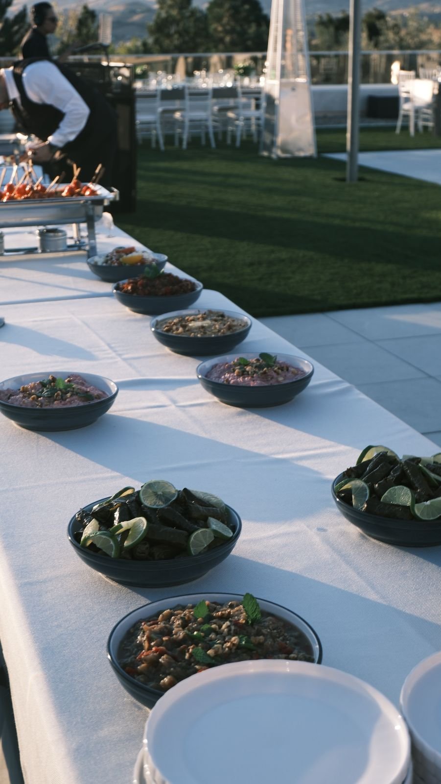 Bowls of salads and meze lined up along a buffet